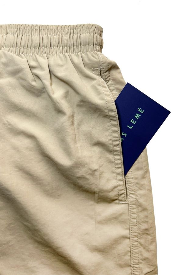 FRONT POCKET OF THE SWIM TRUNKS