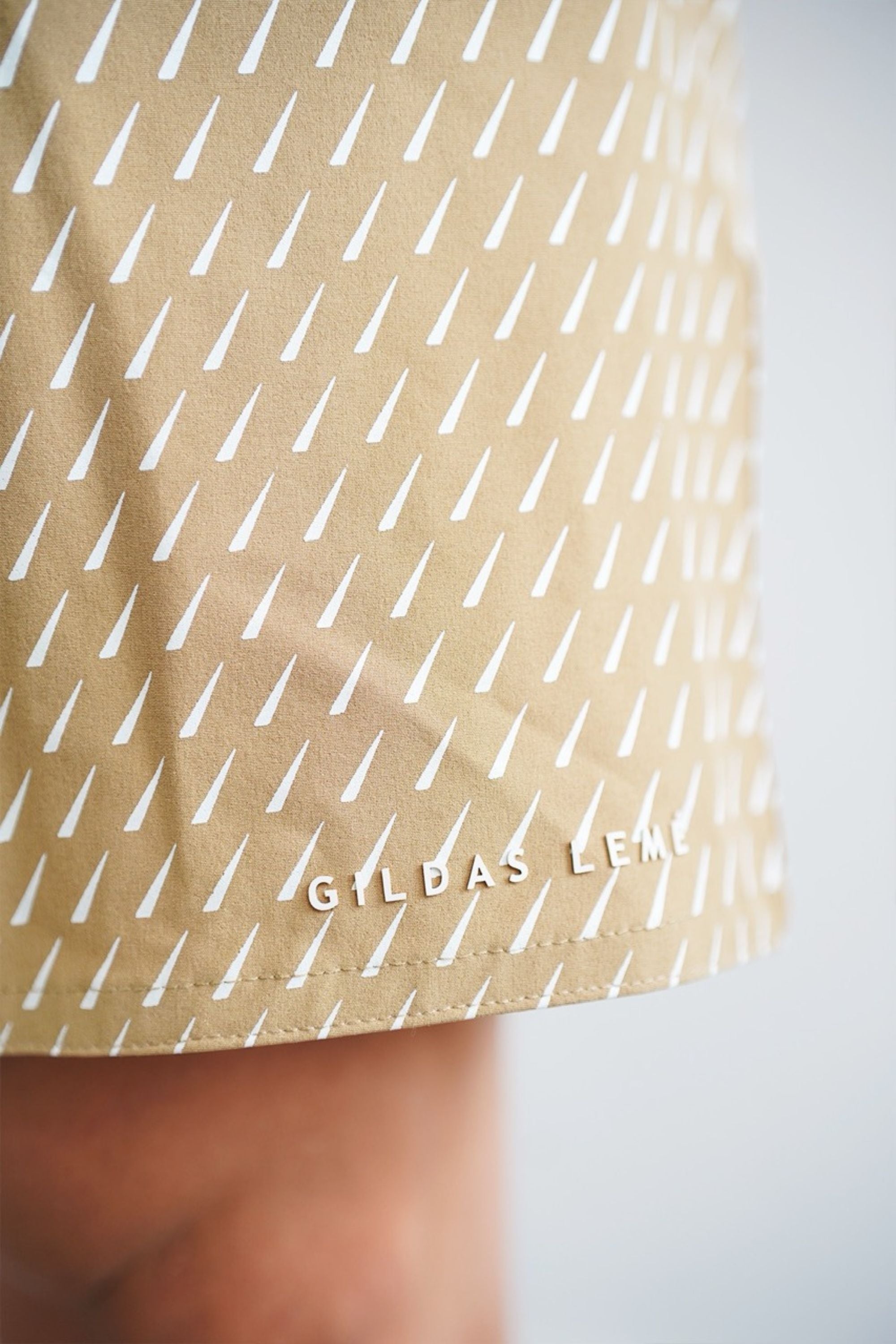 accent swim shorts Beige with white geometric pattern and 'GILBAS LEMÉ' branding #color_beige