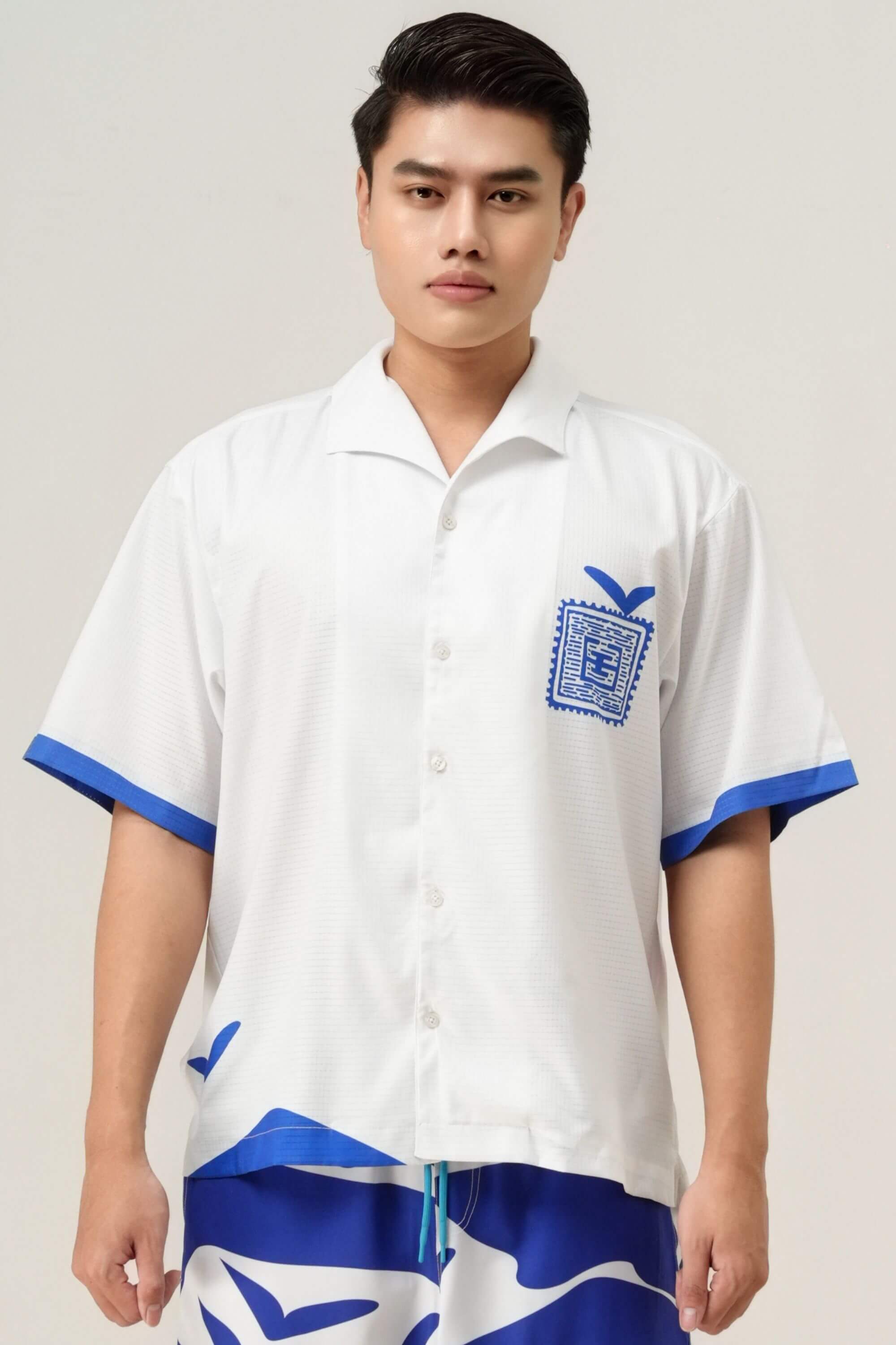 blue stamp resort shirt front view on model #color_white
