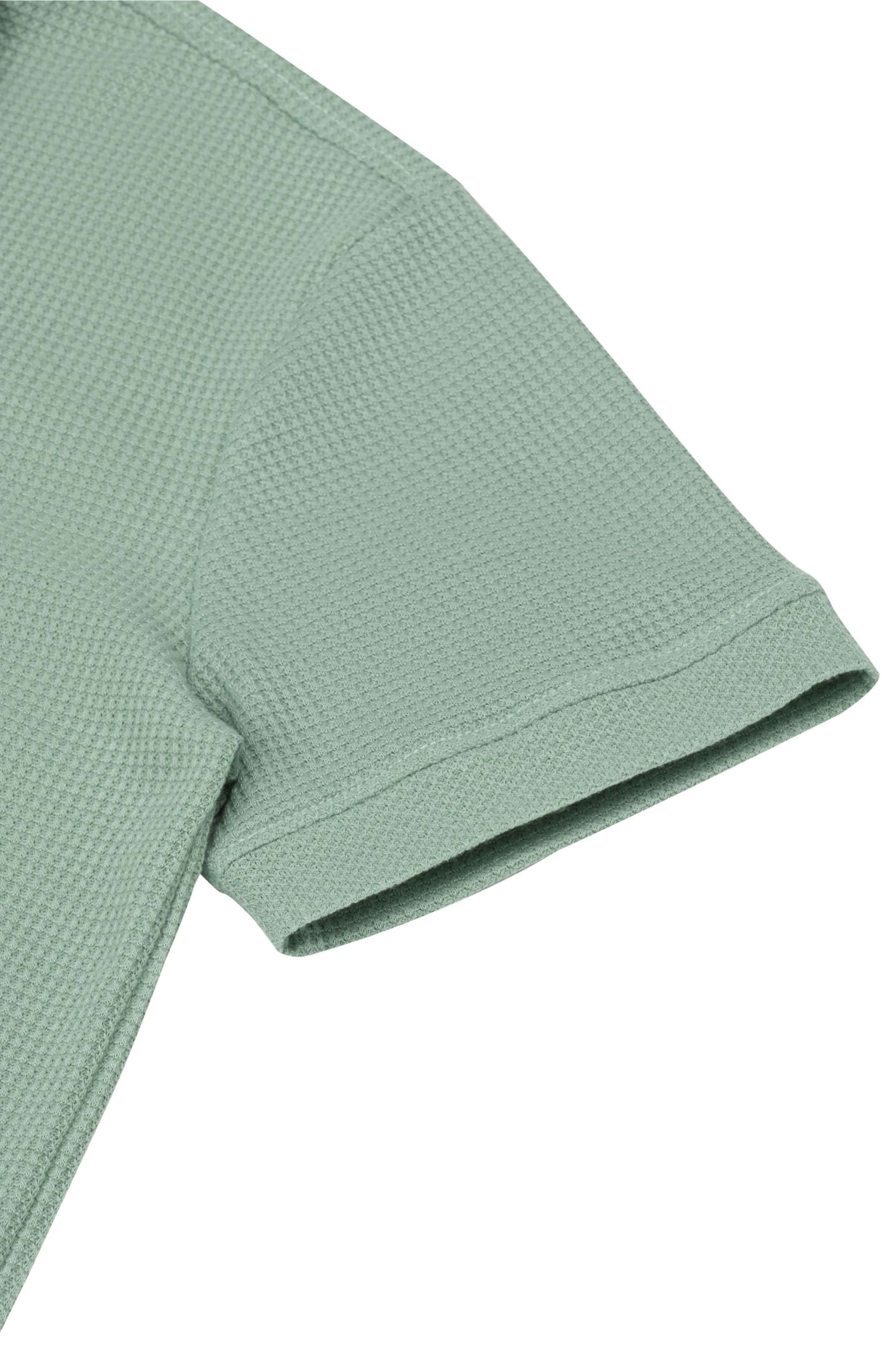 Sleeve detail of Palma men’s polo shirt in mint green