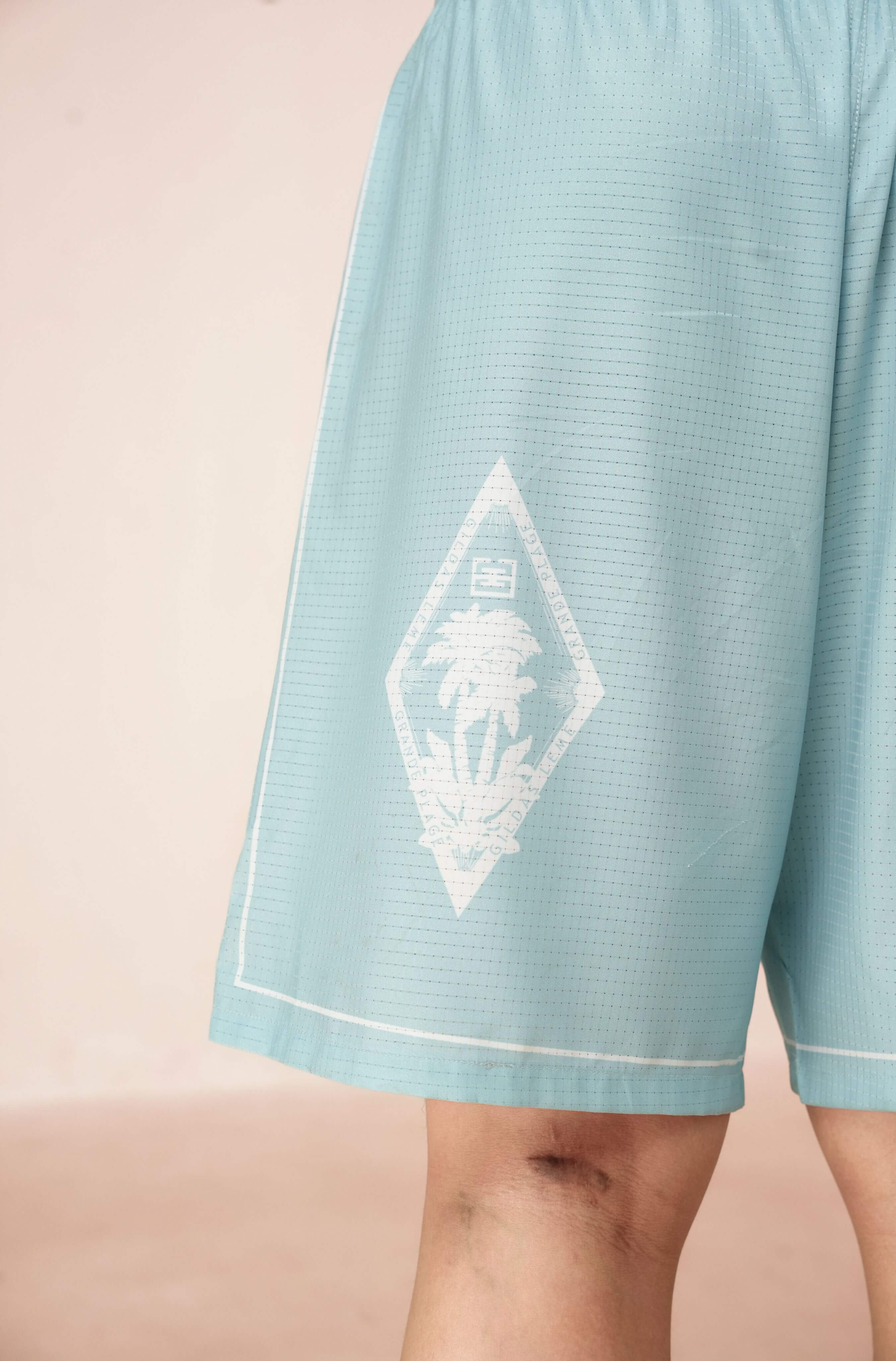 Real-life logo and tag color on Pink Paradise blue resort shorts for men