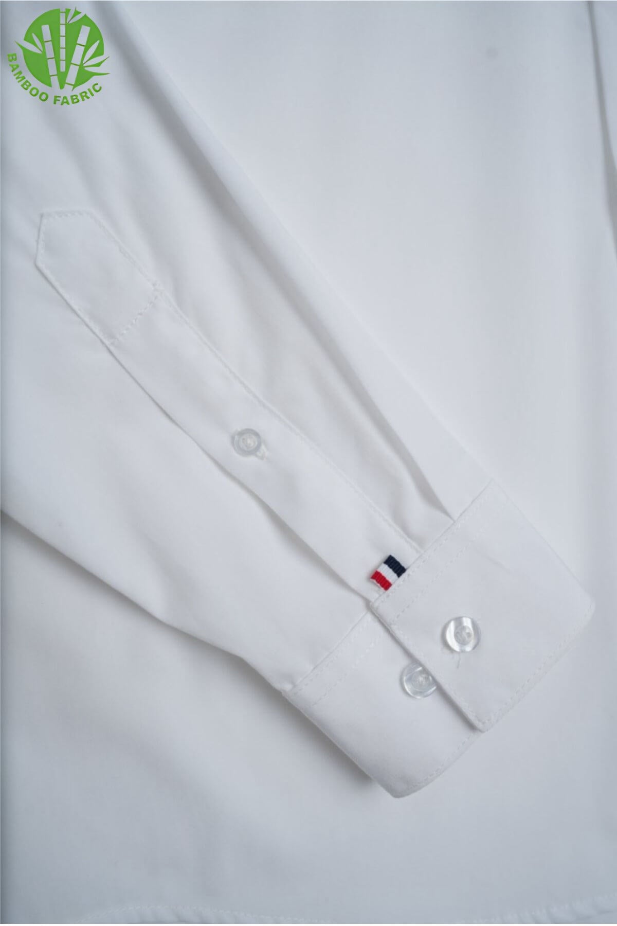 Sleeve detail of men’s white bamboo Riviera long sleeve shirt – breathable, soft fabric with clean, minimal tailoring