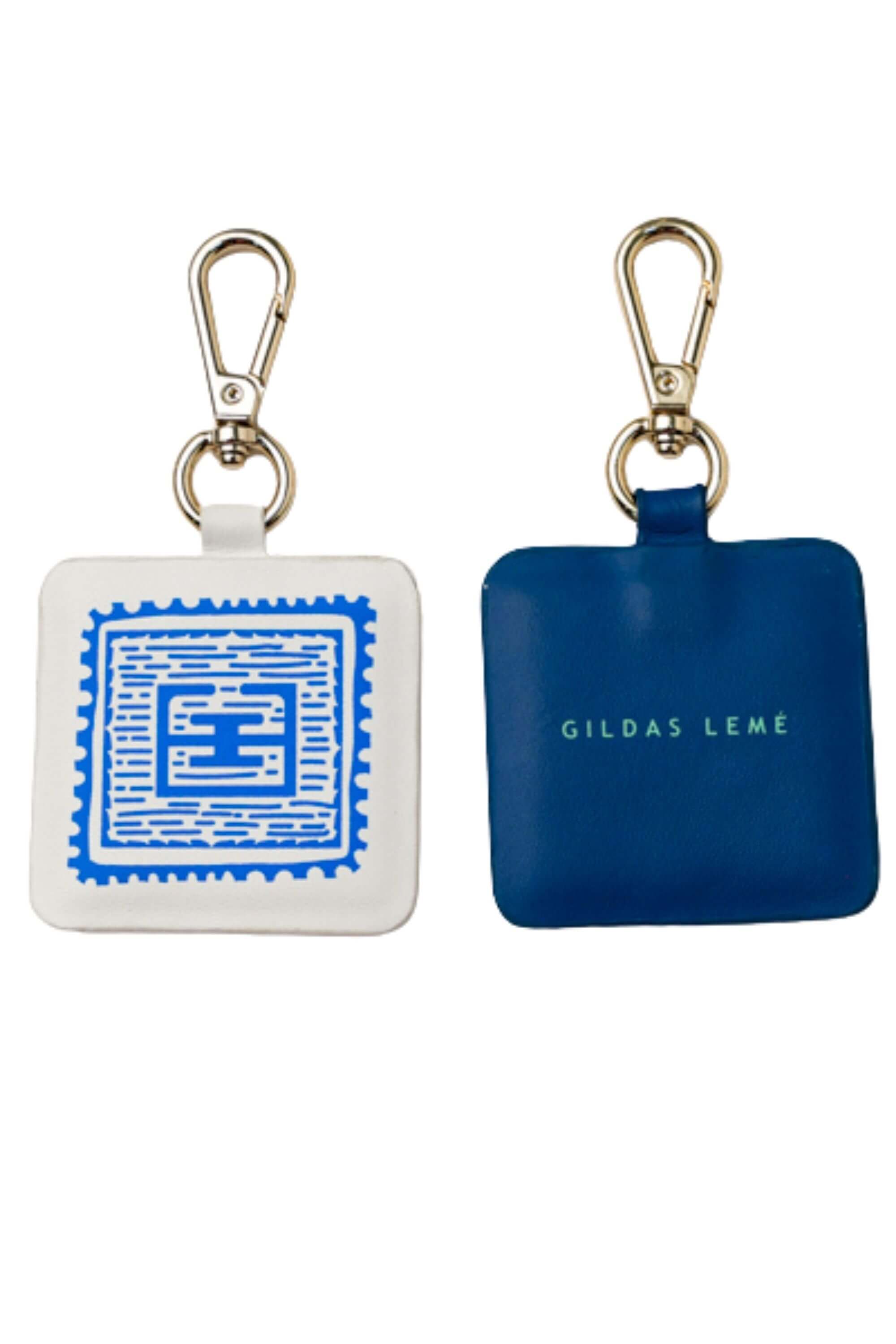 Two blue stamp edition bag charms - navy and white