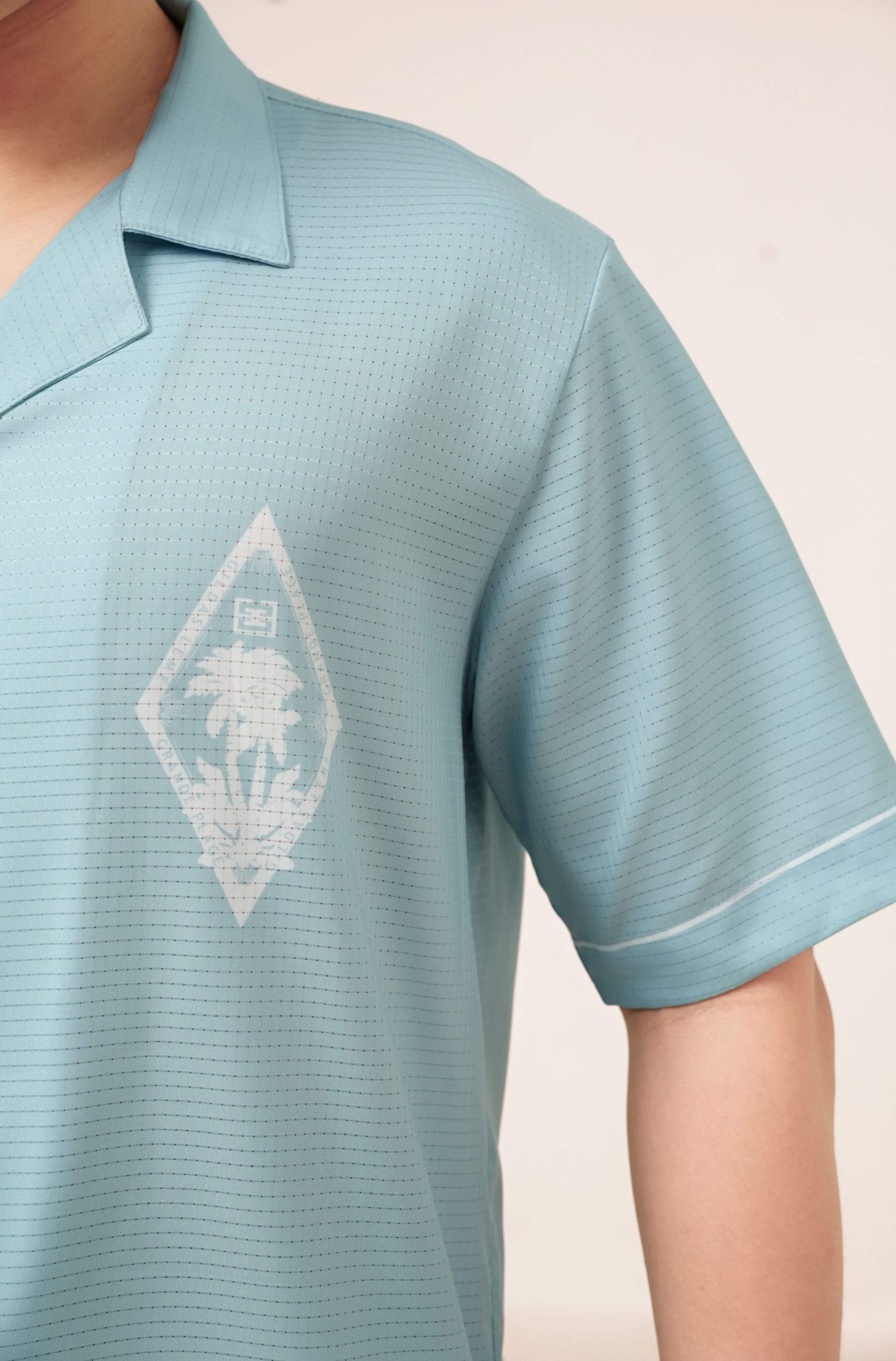 Real-life printed logo on left chest of men’s resort shirt