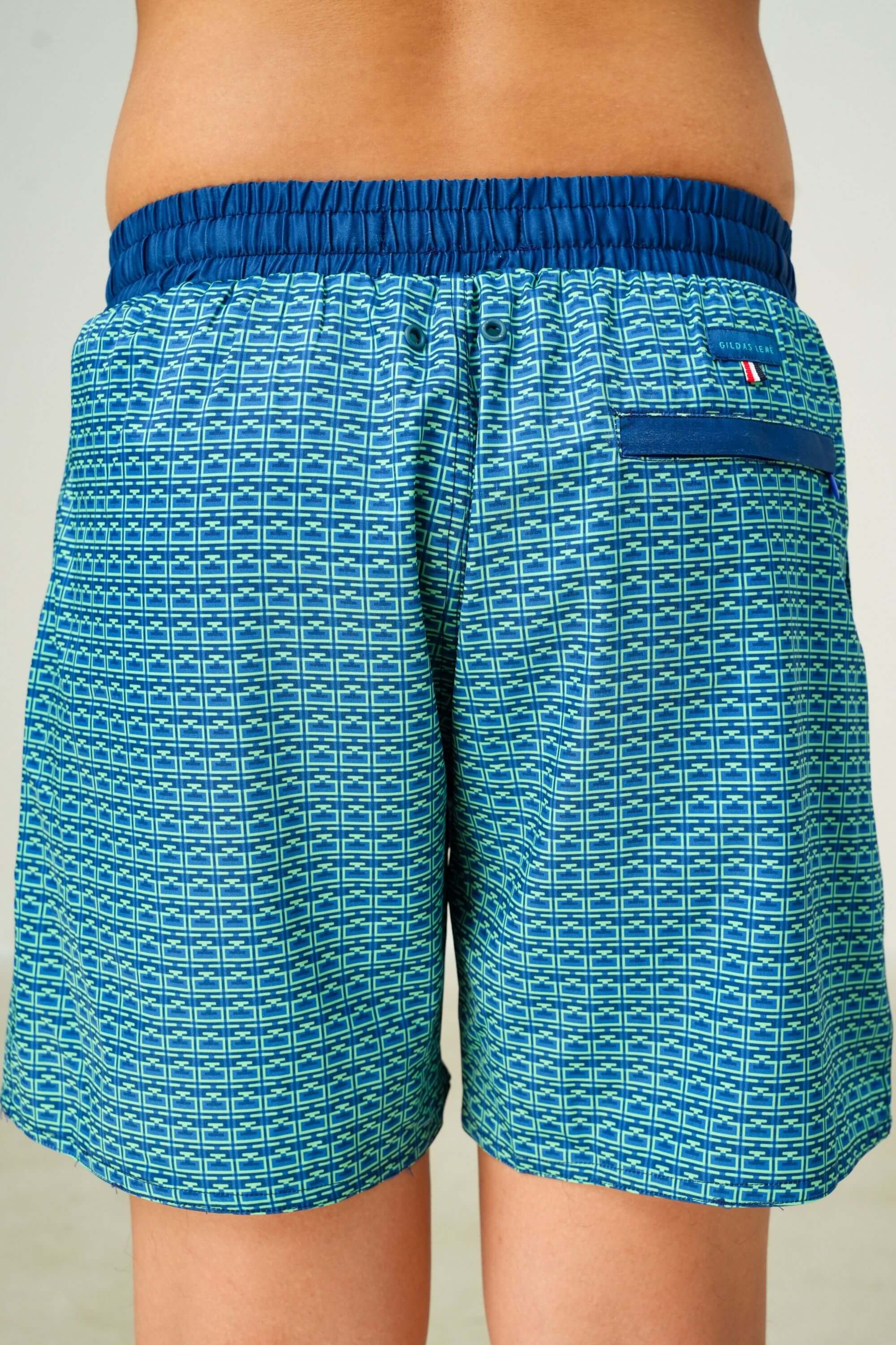 monogram edition swim trunk ocean green back view on model #color_ocean green