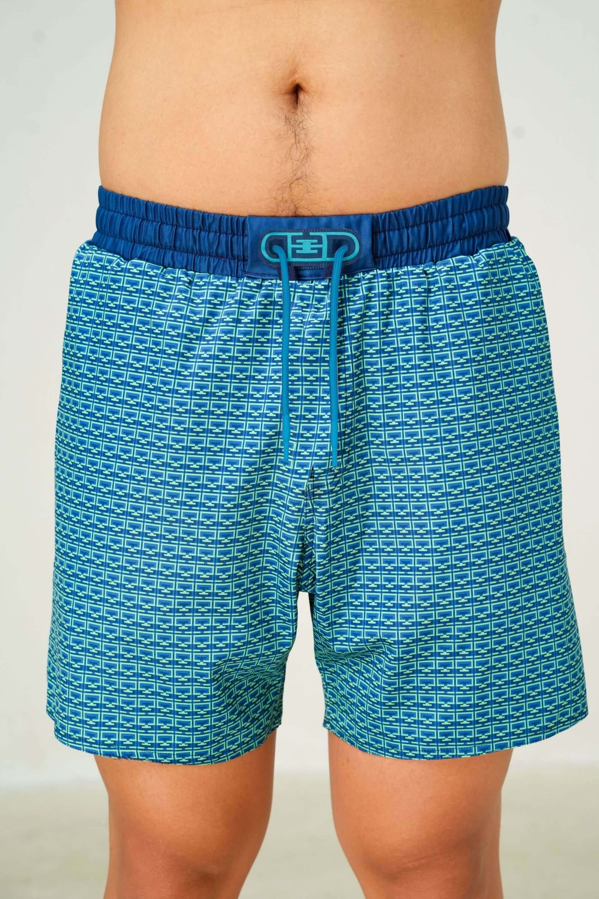 monogram edition swim trunk ocean green front view on model #color_ocean green