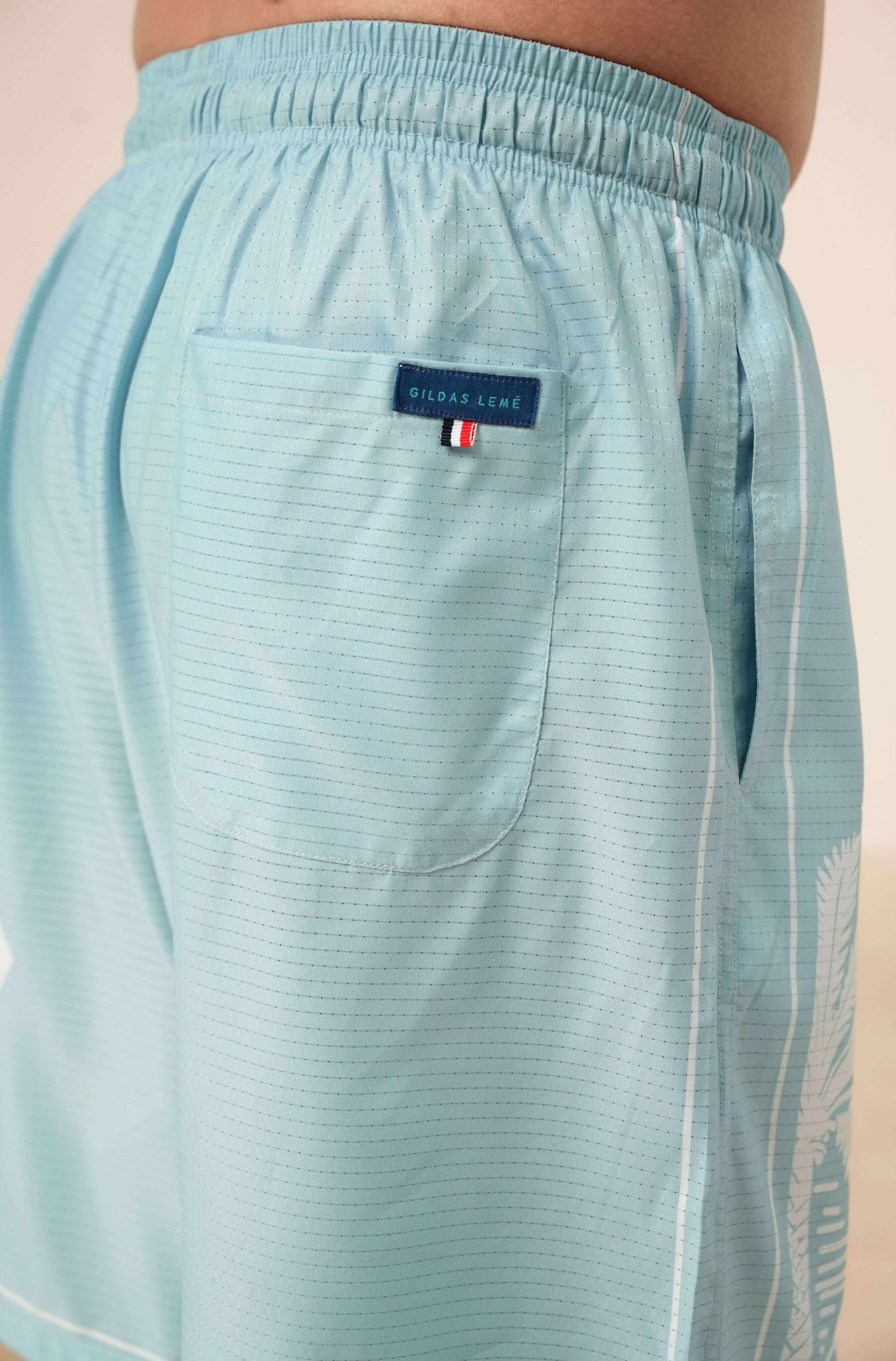 Real back pocket and label color of Pink Paradise blue resort shorts for men